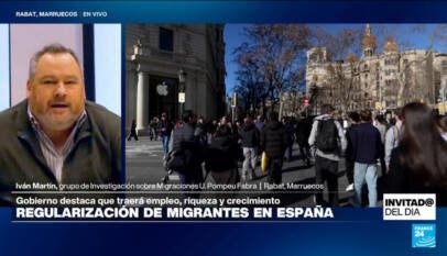 ¿Qué factores impulsaron la regularización de 500.000 migrantes en España?